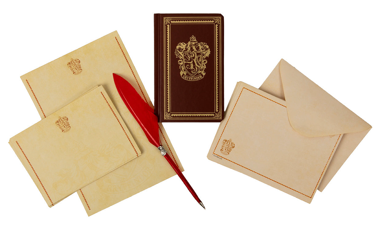 Gryffindor desktop stationery set with pen from Harry Potter Insight Editions, featuring colorful themed notebooks and writing accessories.