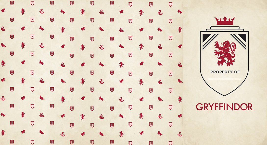 Gryffindor hardcover ruled journal featuring Harry Potter and Hogwarts crest by Insight Editions, open to lined pages.