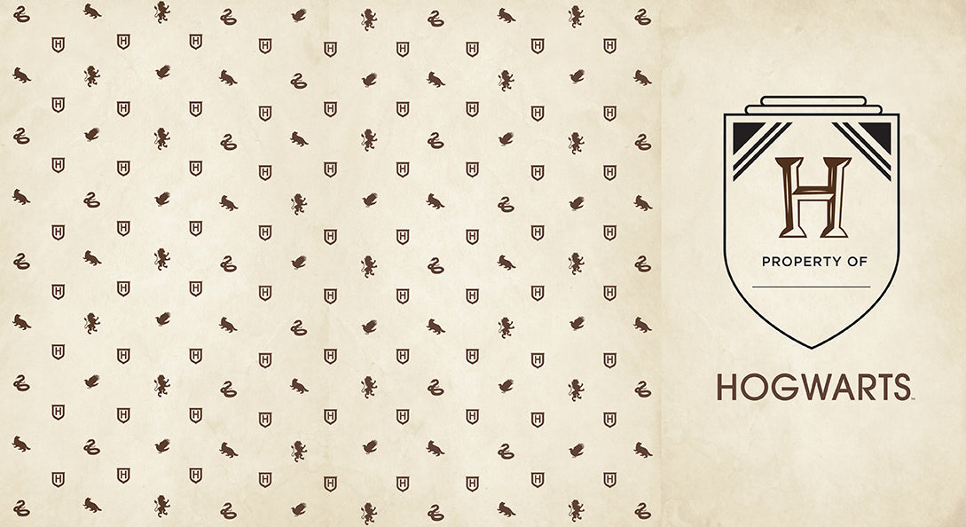 Harry Potter Hogwarts hardcover ruled journal with dark cover and gold embossed details, open to show lined pages.