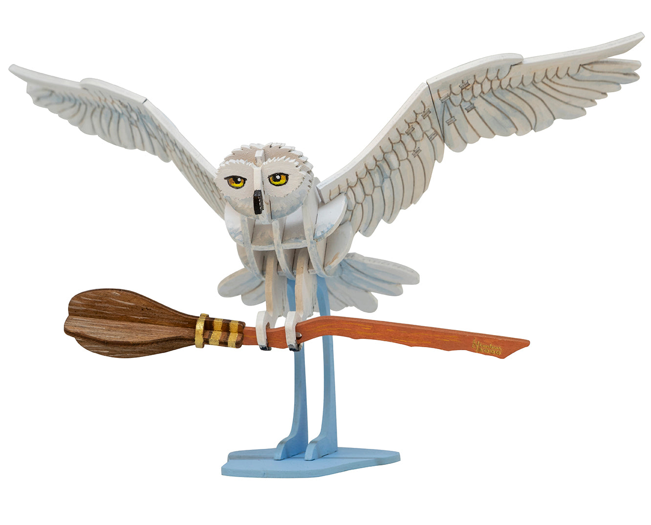 Open softcover Harry Potter Hedwig book and 3D wood model by Insight Editions, featuring detailed illustrations and craftsmanship.