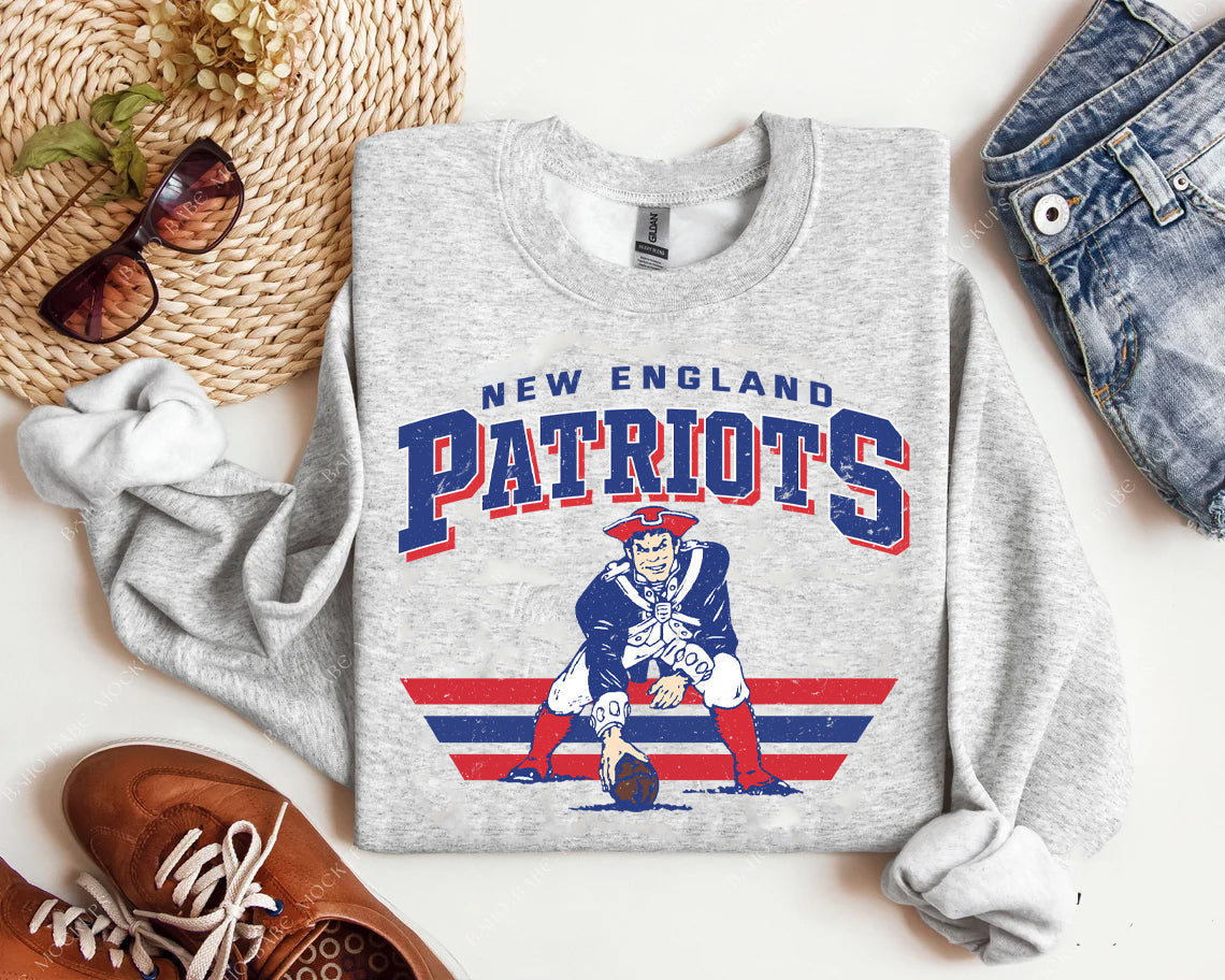 Vintage Team Patriots graphic tee by Anchored Grace Boutique featuring a retro sports-themed design on cotton fabric.