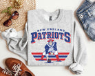 Vintage Team Patriots graphic tee by Anchored Grace Boutique featuring a retro sports-themed design on cotton fabric.