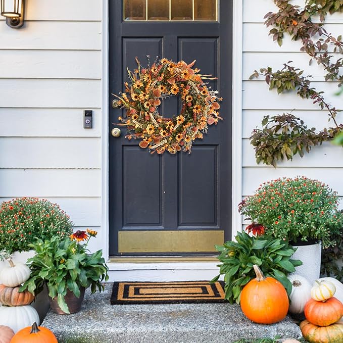 Colorful 22-inch artificial floral wreath with daisies and autumn foliage by CozyNest Decor, perfect for fall door, wall, or window decor.