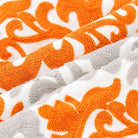 CozyNest Decor orange floral and geometric embroidery throw pillow cover, 18x18 inches, cotton farmhouse cushion for sofa or bed.