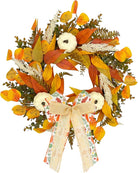 Rustic fall wreath with white pumpkins, golden eucalyptus, wheat, and a bow, perfect for front door autumn decor.