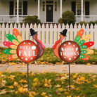 Two CozyNest Decor metal Thanksgiving yard stakes with LED lights featuring turkeys and fall harvest designs for garden or lawn decor.