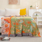 CozyNest Decor boho fall throw blanket with floral print in orange and sage green, 90x98 inches, soft breathable cotton for bed or sofa.