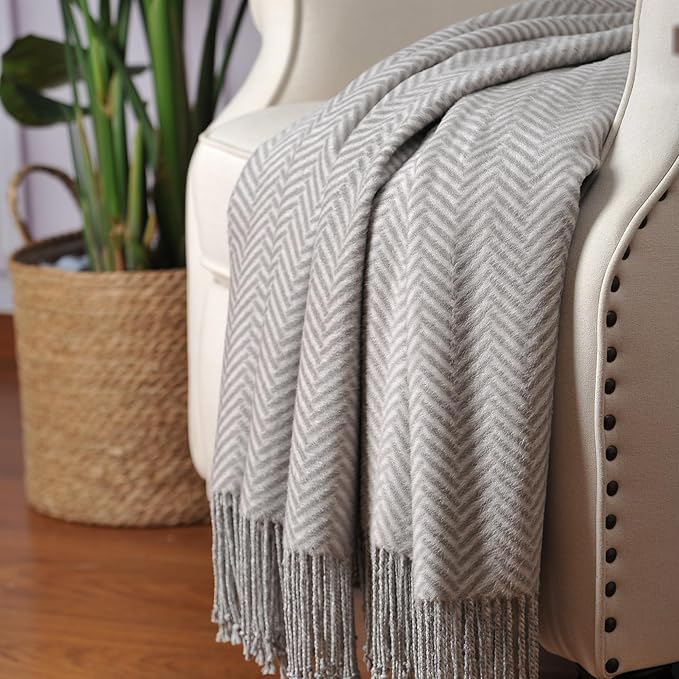 CozyNest Decor Cuddle Dreams silk throw blanket in herringbone gray with hand-knotted fringe, soft, breathable, and natural fabric.
