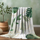 Sage green leaf throw blanket by CozyNest Decor, soft flannel with gold accents, decorative boho pattern for couch or bed, 50x60 inches.