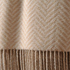 CozyNest Decor silk throw blanket with hand-knotted fringe in taupe, soft, breathable, and featuring a herringbone pattern.