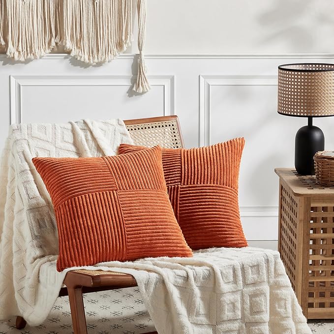 Set of 2 burnt orange decorative throw pillow covers with textured patchwork, perfect for living room or bedroom decor.