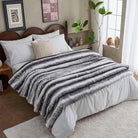 Luxury Faux Fur Blanket by CozyNest Decor, soft black and white plush bed throw on a sofa, fluffy and reversible for cozy comfort.