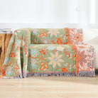 CozyNest Decor boho fall throw blanket with floral print in orange and sage green, soft breathable 100% cotton for bed or sofa.