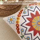 Orange embroidered throw pillow cover with boho floral pattern, 18x18 inch, cozy textured cushion cover for sofa or outdoor decor.
