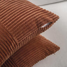 Rust-colored boho decorative throw pillow covers from CozyNest Decor, 18x18 inch soft corduroy patchwork for sofa or bed decor.