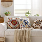 Orange embroidered throw pillow cover from CozyNest Decor with boho floral pattern, textured fabric, suitable for sofa or bed decor.