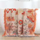 CozyNest Decor boho fall throw blanket in orange and sage green with floral print, soft breathable cotton for bed or sofa decor.
