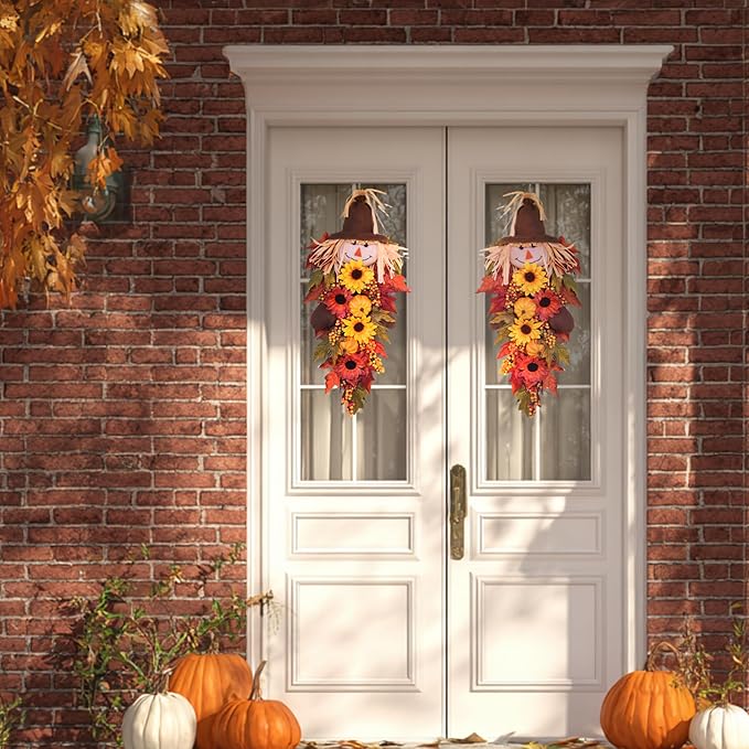 Rustic 24-inch fall scarecrow teardrop swag with sunflowers, pumpkins, and autumn accents for farmhouse decor on door or wall.