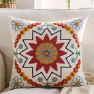 Orange embroidered throw pillow cover with boho floral pattern, cozy textured fabric, ideal for sofa, bed, or outdoor decor.