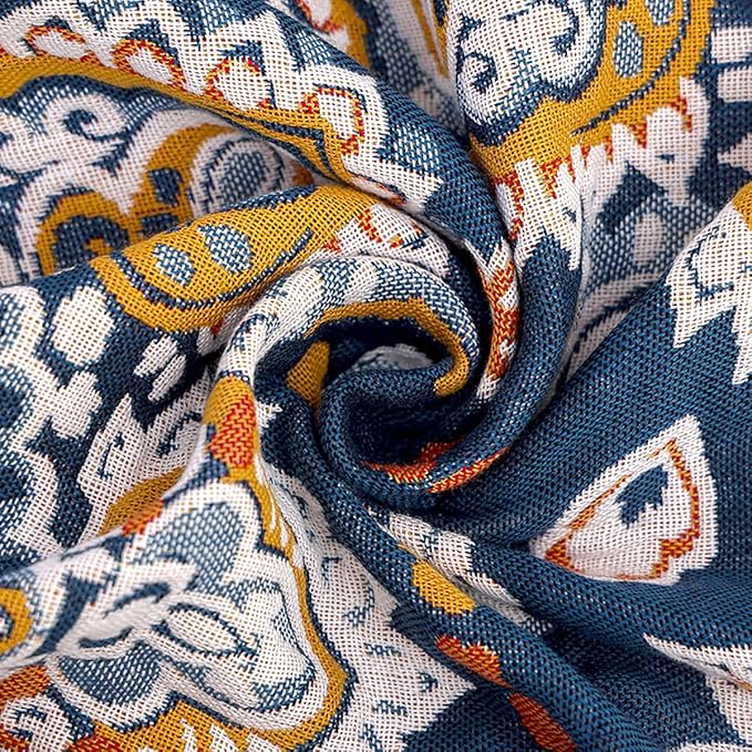 Twin size boho muslin blanket by CozyNest Decor, soft 4-layer cotton summer blanket with spiral flower design for sofa or bed.