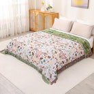 CozyNest Decor boho cotton throw blanket with floral and animal prints, large rustic quilt for bed, sofa, or chair, 90x98 inches.