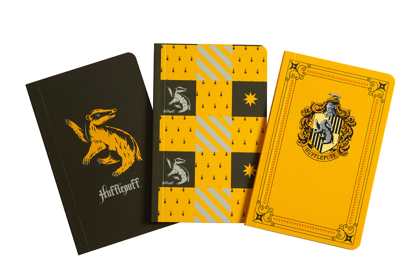 Set of three Harry Potter Hufflepuff softcover pocket notebooks from Insight Editions, featuring colorful covers and Hufflepuff house symbols.