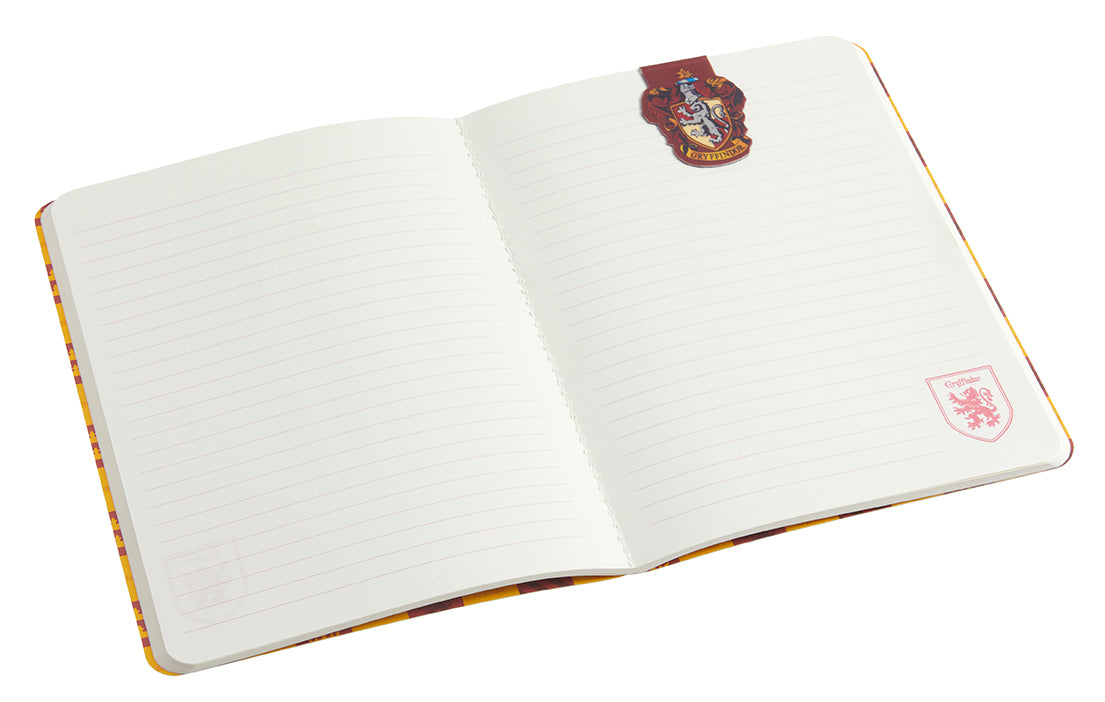 Inside view of a Harry Potter Gryffindor notebook and page clip set, with softcover cover and gold foil accents, branded by Insight Editions.