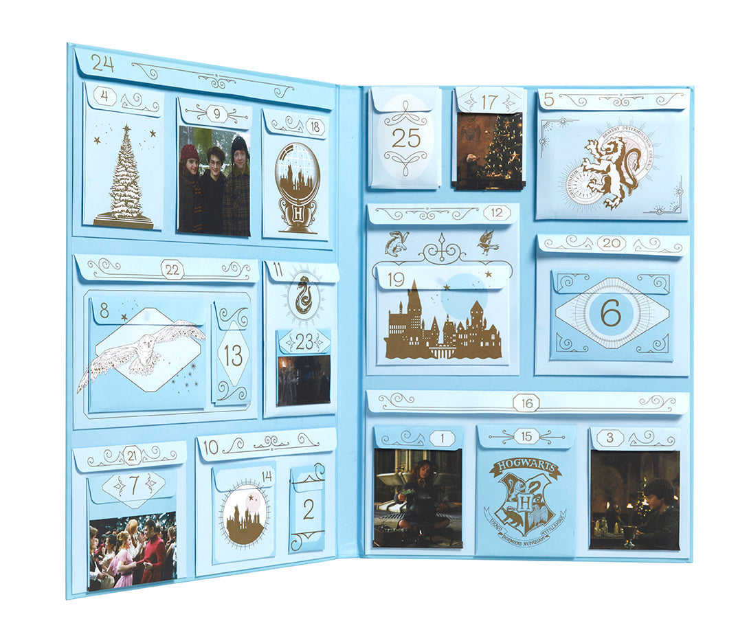 Inside view of the hardcover Harry Potter Holiday Magic Advent Calendar by Insight Editions, featuring magical illustrations and numbered doors.