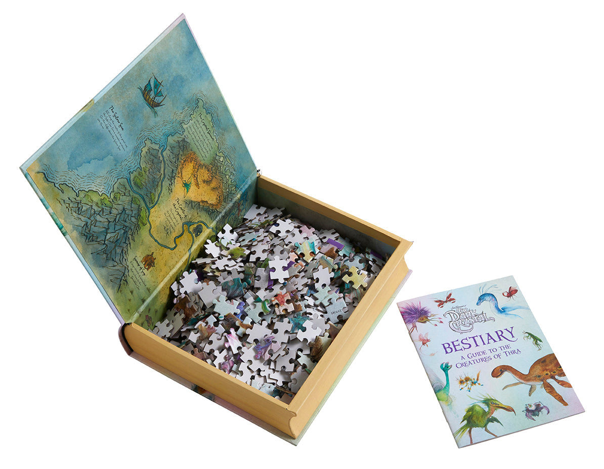 Inside view of Jim Henson's The Dark Crystal Bestiary puzzle and book set by Insight Editions, showing detailed pages and puzzle pieces.