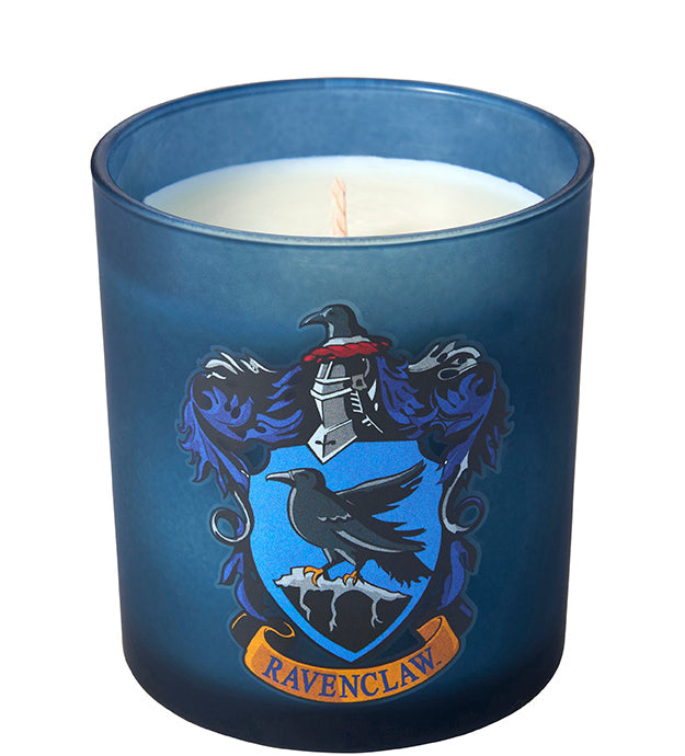 Ravenclaw scented glass candle from Harry Potter home goods collection, featuring blue glass with Ravenclaw crest design.
