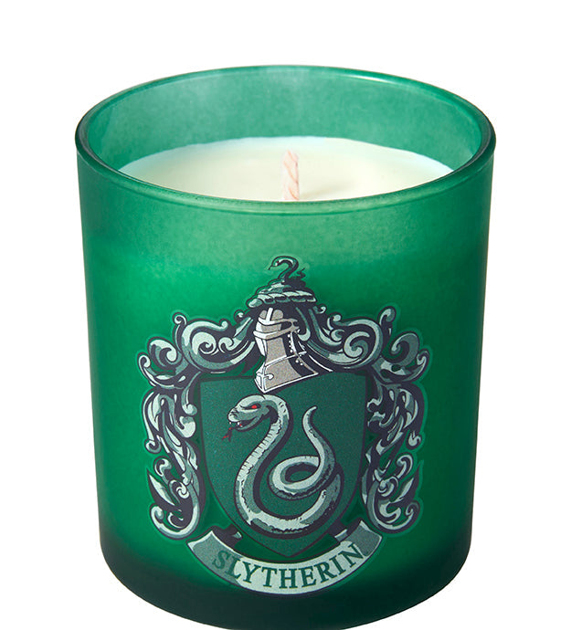 Slytherin scented glass candle from Harry Potter home goods collection by Insight Editions, featuring green glass and Hogwarts branding.