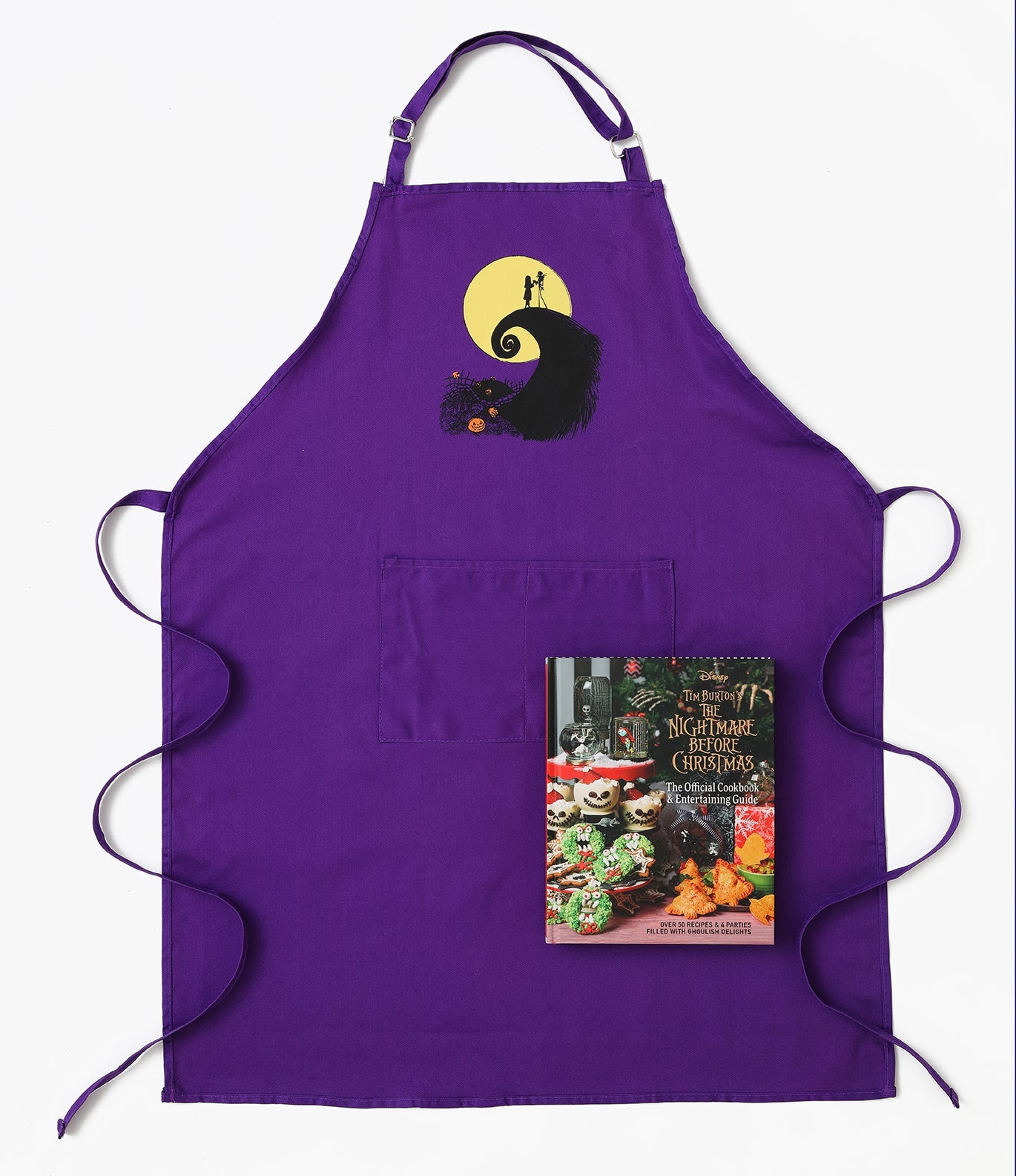 Open hardcover of The Nightmare Before Christmas official cookbook and entertaining guide by Insight Editions, showcasing spooky themed pages.