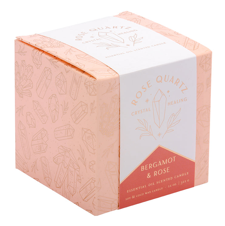 Rose quartz crystal healing scented glass candle on a wooden table, perfect for home decor and relaxation.
