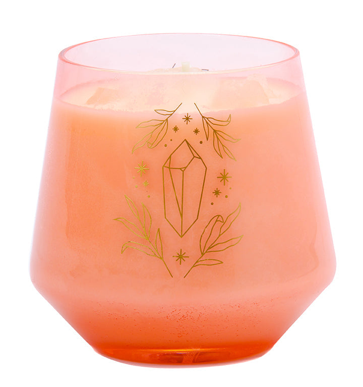 Rose quartz crystal healing scented glass candle from Insight Editions, with a soft pink candle and crystal on a decorative tray.