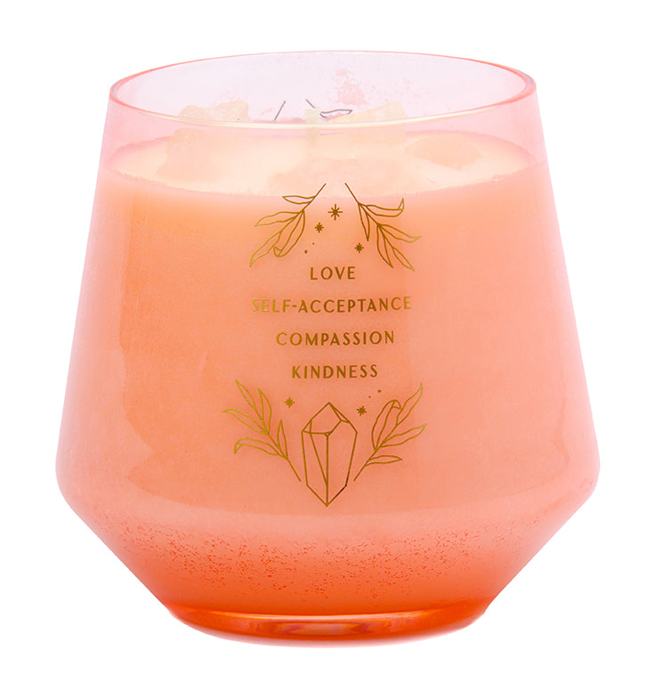 Rose quartz crystal embedded in a glass scented candle for healing and relaxation, part of Insight Editions' home goods collection.