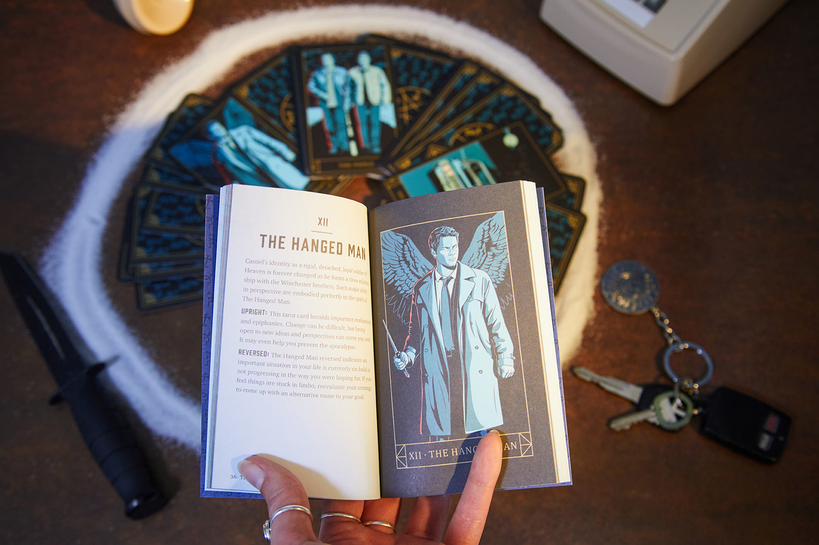 Insight Editions Supernatural Candle and Tarot Card Deck Bundle with lit candle and tarot cards on a mystical table scene