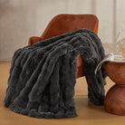Dark grey JELLYMONI Faux Fur Throw Blanket by CozyNest Decor, plush and cozy bed blanket, 50x60 inches, thick and warm.