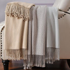 CozyNest Decor Cuddle Dreams silk throw blanket with hand-knotted fringe in taupe, soft, breathable herringbone pattern.