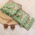 CozyNest Decor boho cotton throw blanket with floral and animal prints, large rustic quilt for bed, sofa, or chair, 90x98 inches.