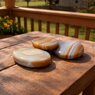 Banded agate palmstones with colorful natural patterns, polished and smooth, perfect for meditation or decorative display.
