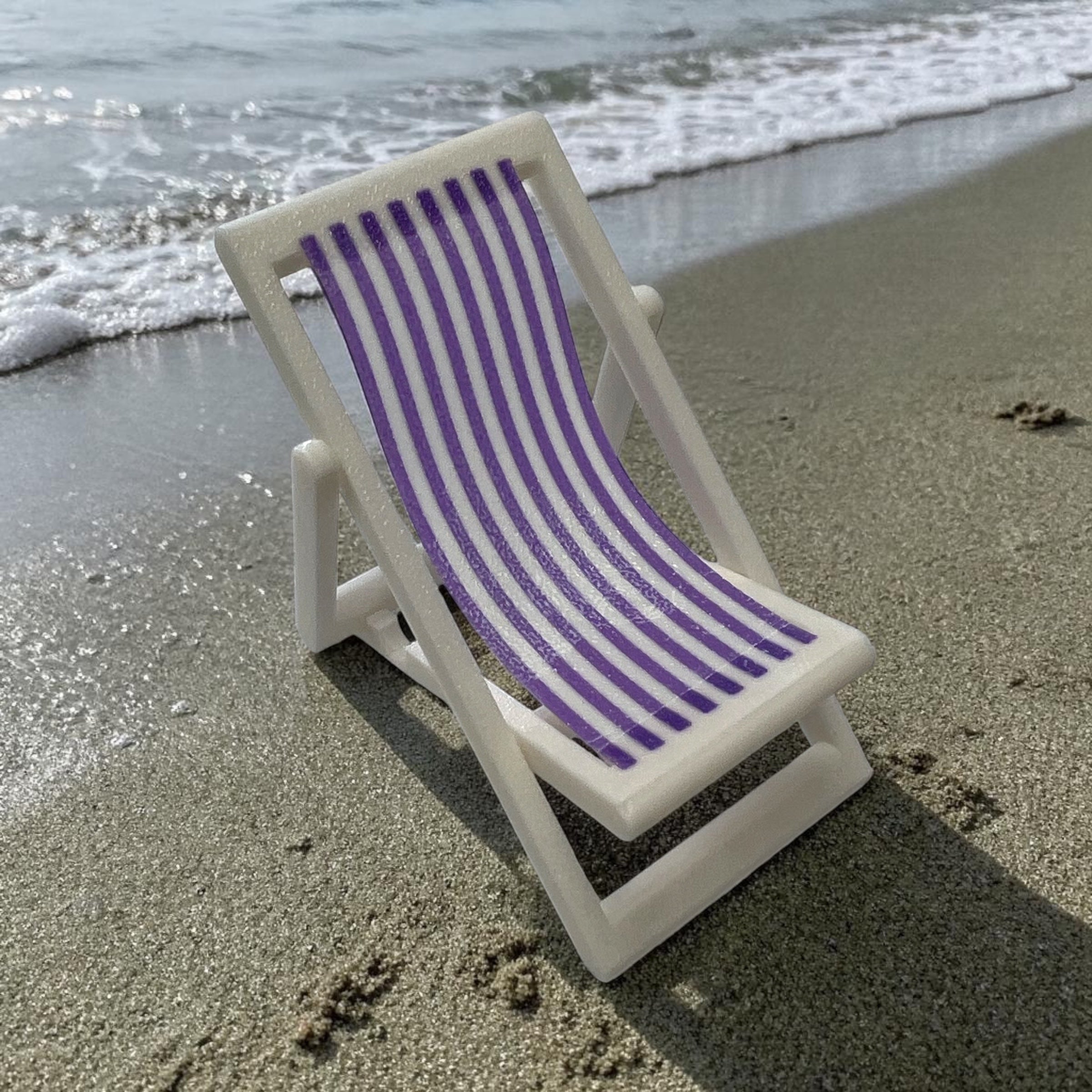 Bug & Bean Freshies beach chair with a stand, featuring a comfortable design and vibrant colors for outdoor relaxation.