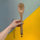 Wooden baking spoon from The Bullish Store in a canvas gift bag, ideal for baking and kitchen cooking utensils.