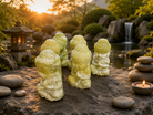 Small jade Buddha statue with intricate carvings, showcasing serene face and tranquil pose, handcrafted by 1 Practical Magic Store.