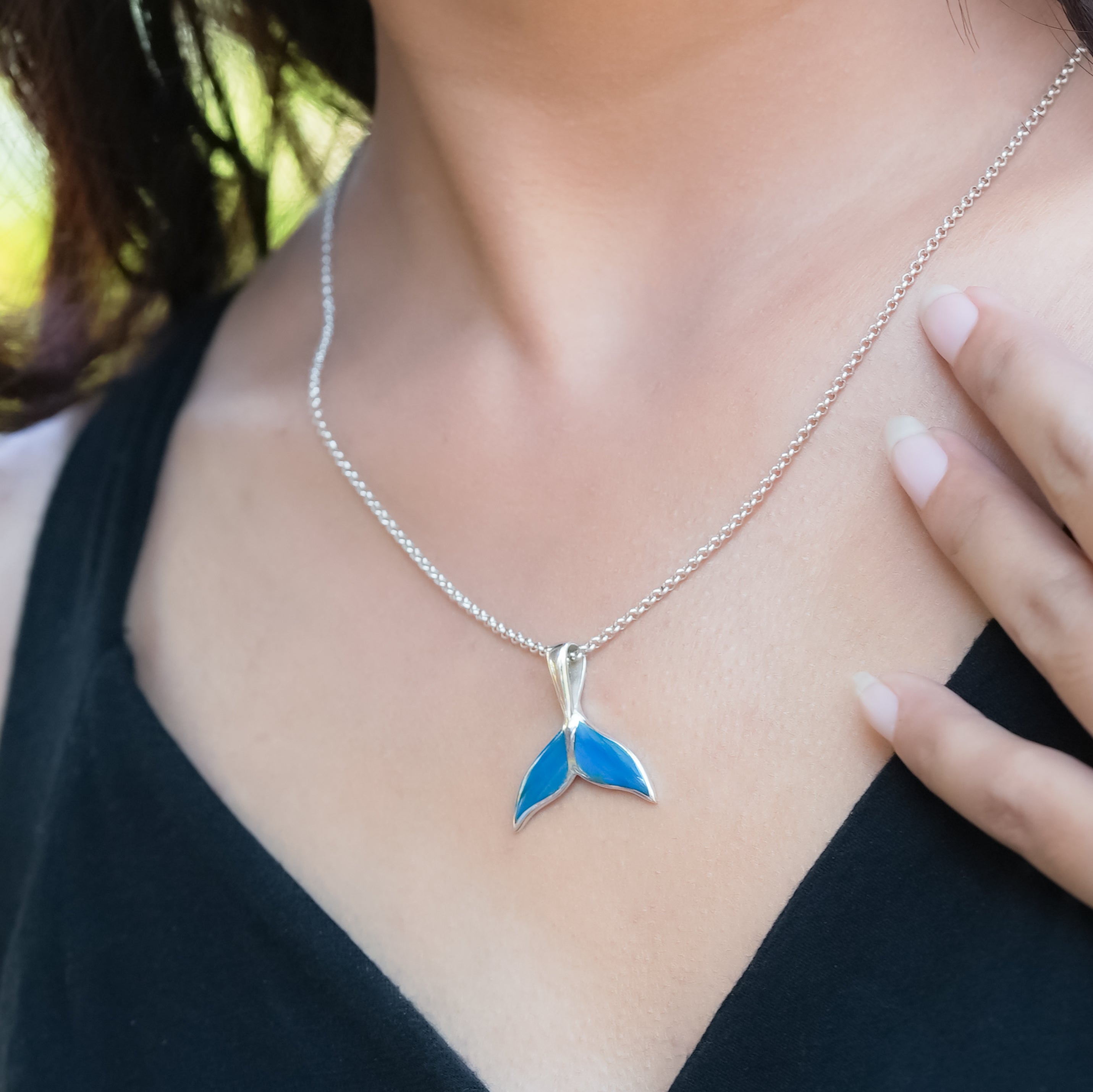 Peruvian blue opal whale tail pendant in sterling silver, crafted by Starborn Creations, with detailed ocean-inspired design.