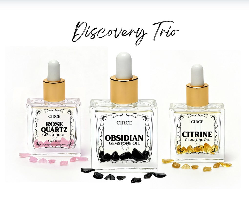 Set of three crystal body oils including rose quartz, citrine, and obsidian in a Circe Boutique discovery set.