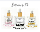 Set of three crystal body oils including rose quartz, citrine, and obsidian in a Circe Boutique discovery set.