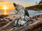 Polished moss agate dolphin figurine with natural green and brown patterns, showcasing smooth craftsmanship and intricate details.