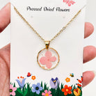Dried flower pendant necklace with an irregular round shape, featuring colorful dried flowers in a glass setting, fashion jewelry.