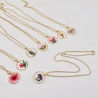 Dried flower pendant necklace with irregular round shape, featuring natural floral design, on a delicate chain, ideal for nature lovers.