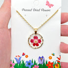 Dried flowers in an irregular round pendant necklace featuring nature-inspired jewelry from The Bullish Store.